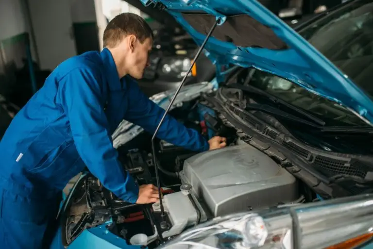 mechanic working on car engine