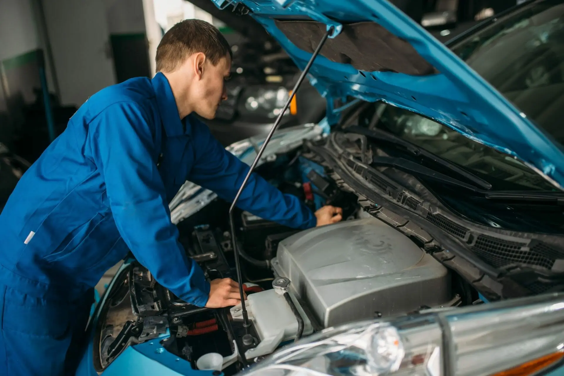 mechanic working on car engine