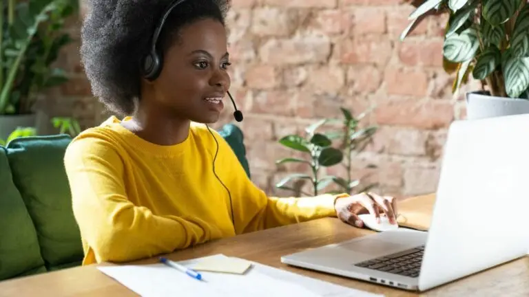 woman on phone at computer using phone system features