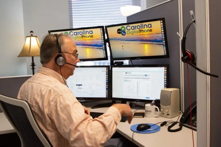 man at desk with headphones