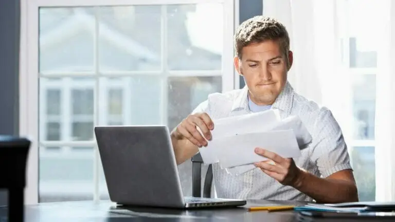 Man reading his digital phone service bills